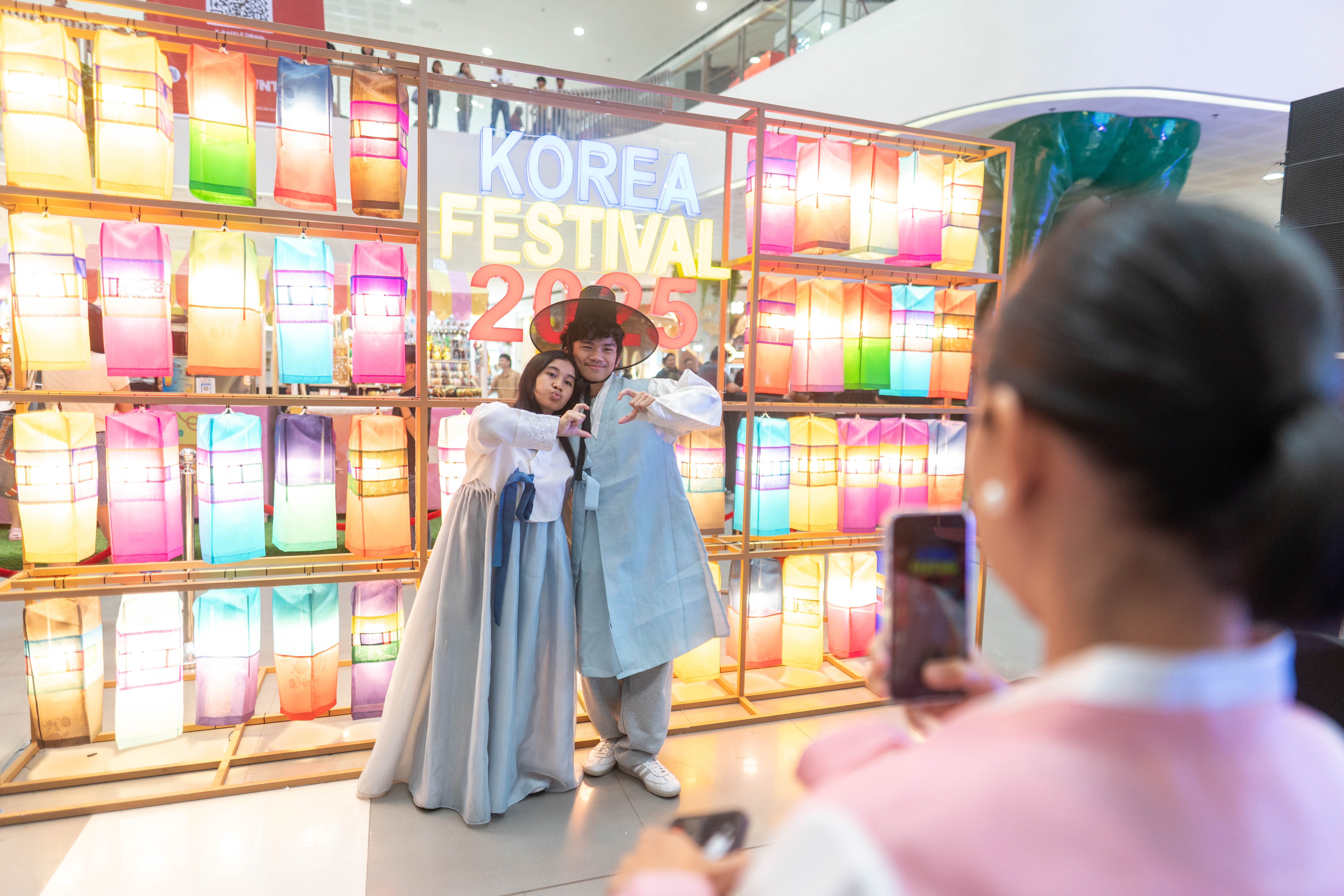 Visitors taking a photo by the Jinju Silk Lights installation